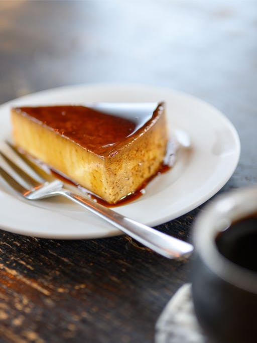 Cheese cake with caramel on a white plate